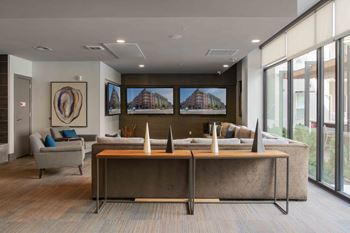 A modern office space with a large desk and a couch.